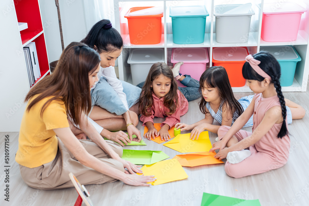 Caucasian beautiful woman teacher teaching a lesson to kid at school. 