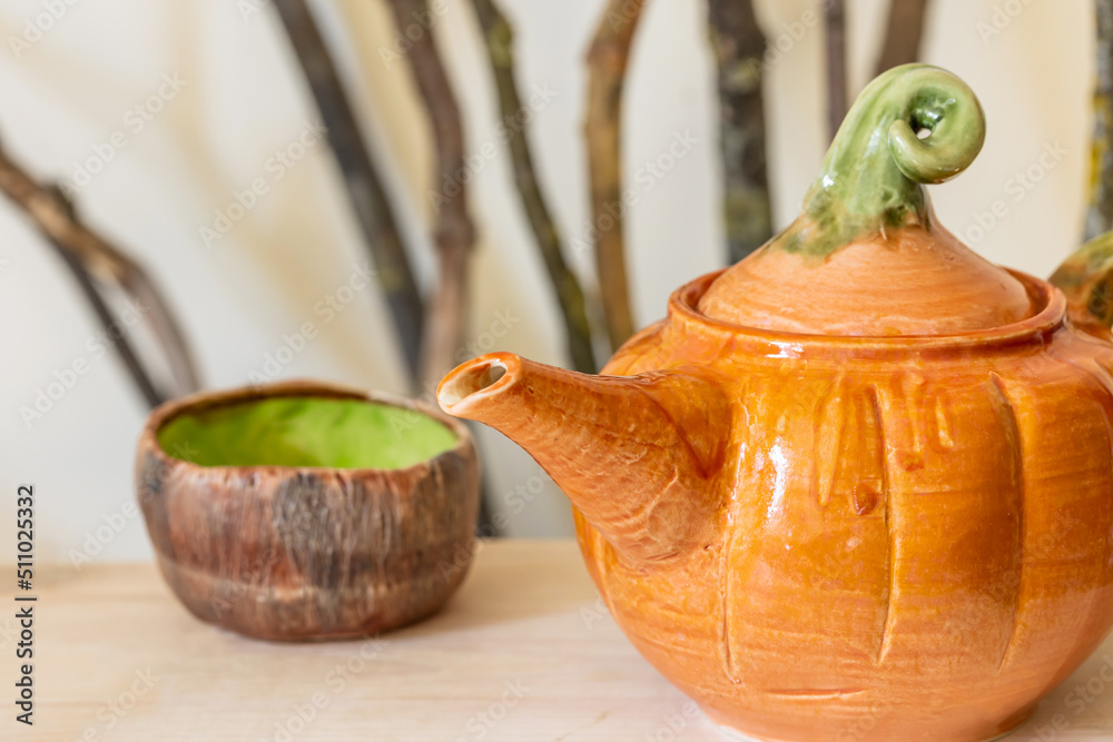 Kettle in the form a pumpkin. Selective focus.