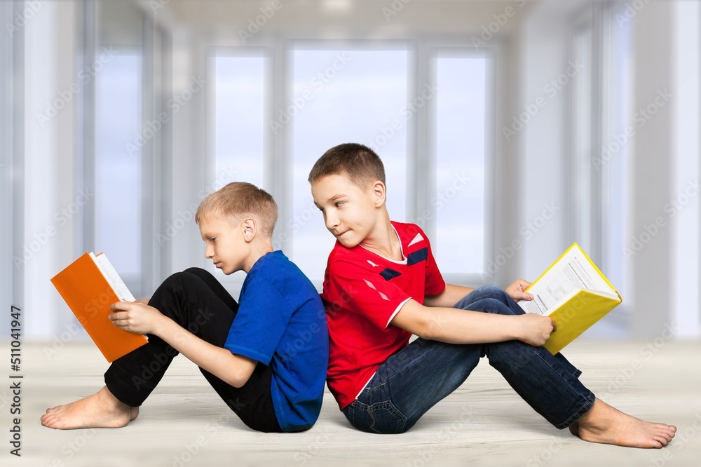 School kids reading book together. Conception of education.