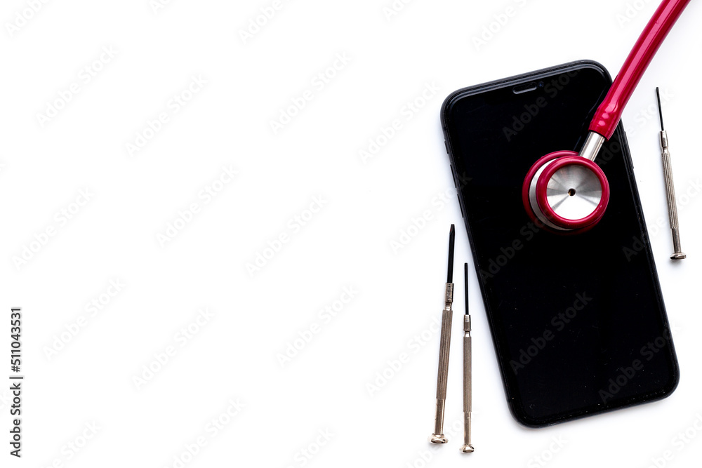 Electronics repair servise concept - mobile phone with stethoscope