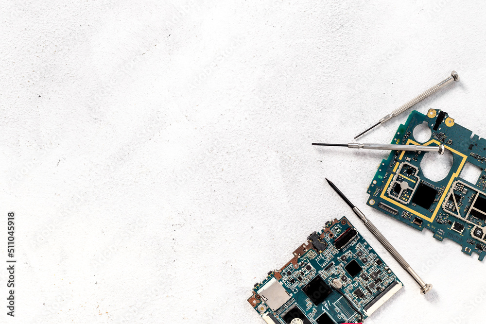 Electronics circuit board with microchips and tools, top view