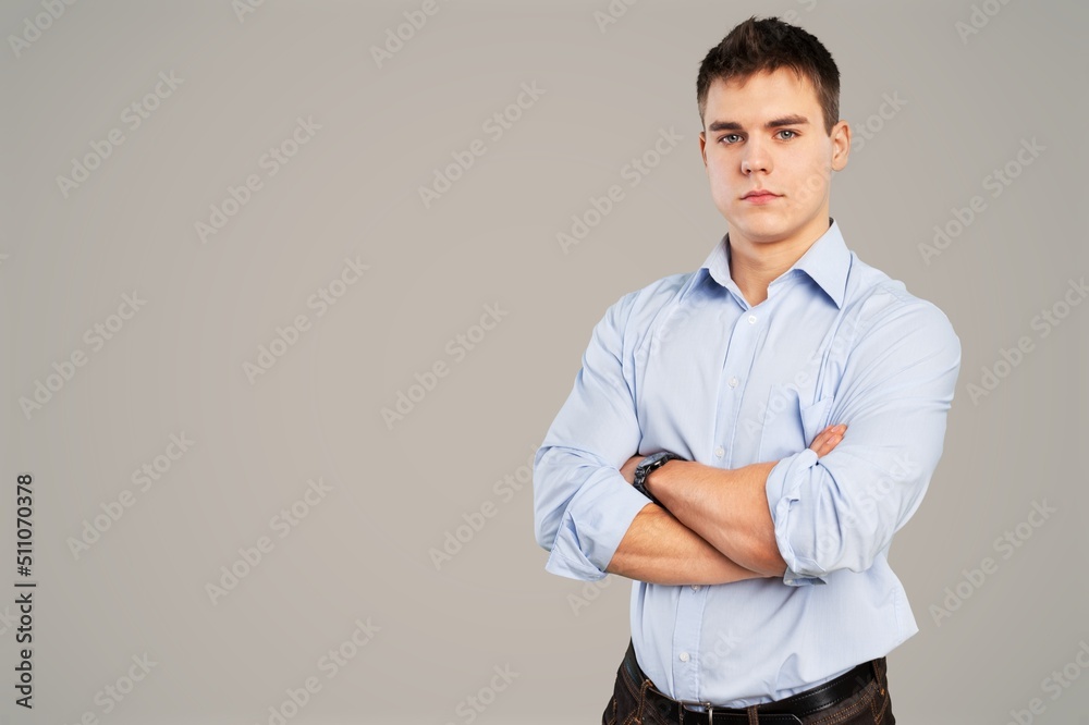 Portrait of smiling young man standing on the background