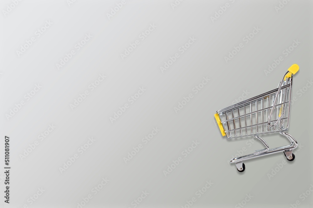 Mini shopping trolley for shopping on background, consumer concept, minimalism. Sale