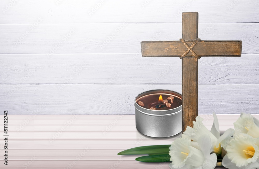 Wooden cross, flowers and candles on table. Religious church holiday. symbol of faith in God, Christ