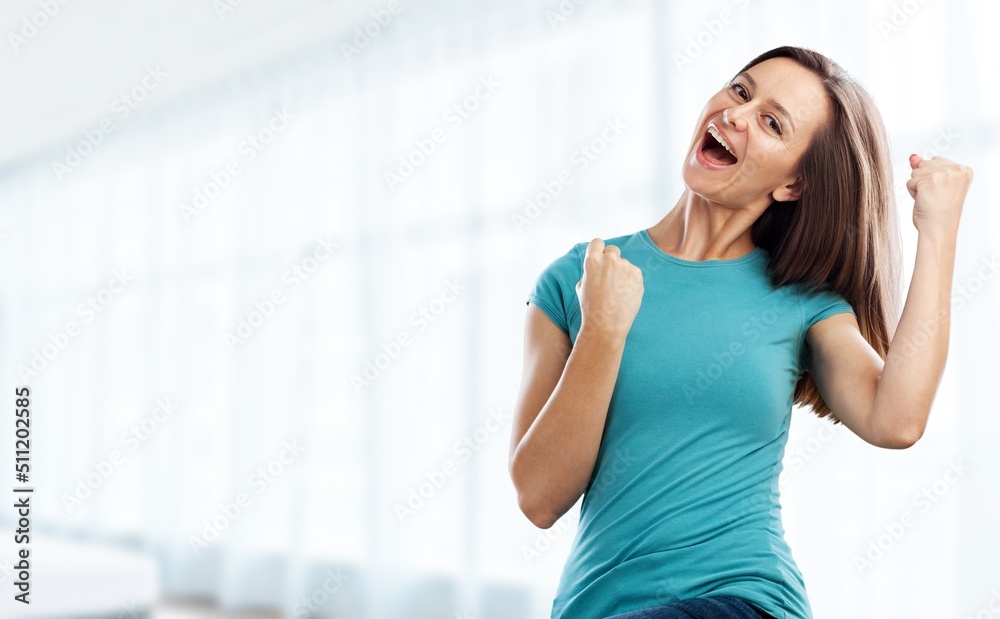 Young female with raised hands celebrating success cheerful positive woman with raised hands