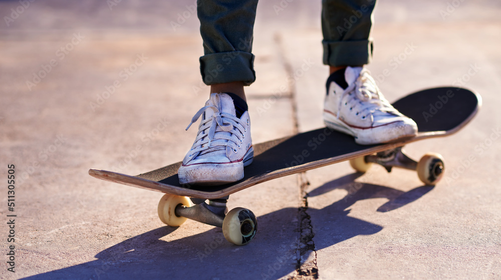 These sneakers were made for skating. A cropped shot of a woman standing on a skateboard.