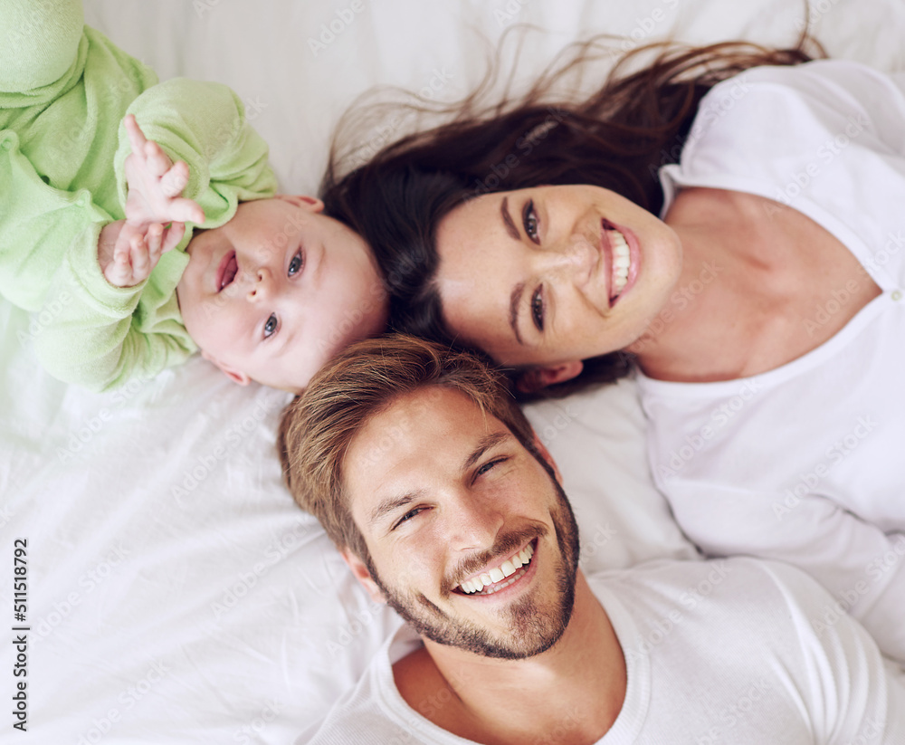 And baby makes three. High angle portrait of a young couple and their baby boy in the bedroom.