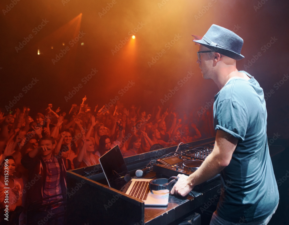 Shot of a young deejay entertaining the crowd at a concert. This concert was created for the sole pu