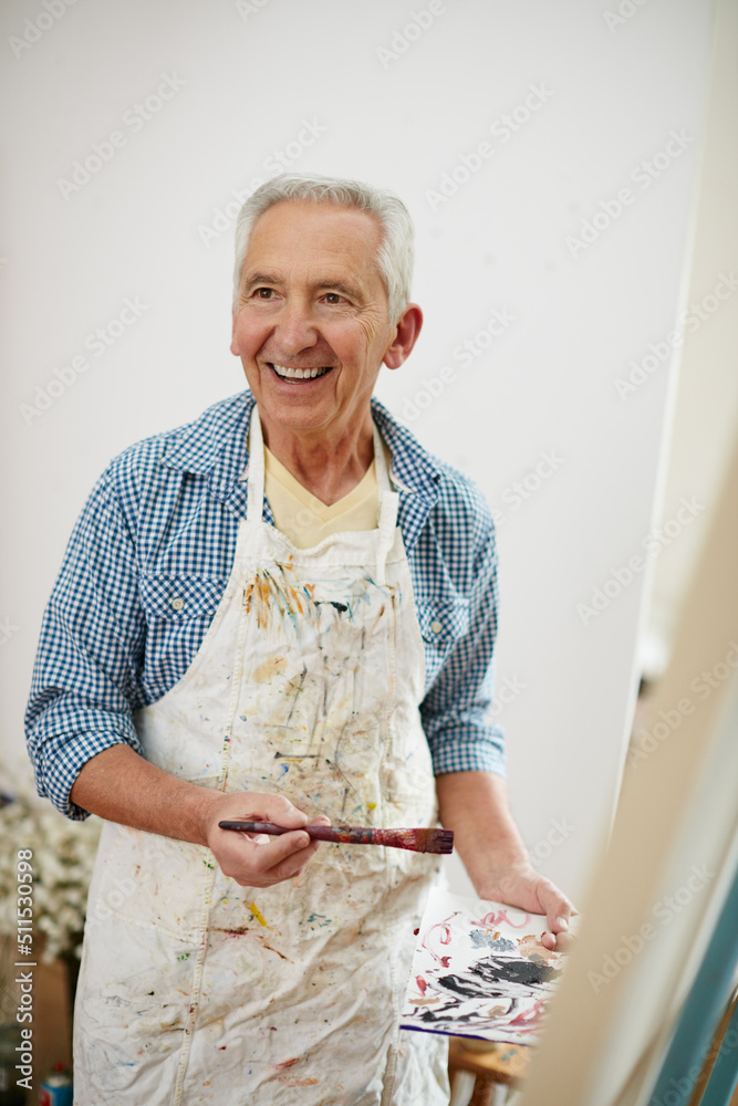 Take time to do what makes your soul happy. Shot of a senior man working on a painting at home.