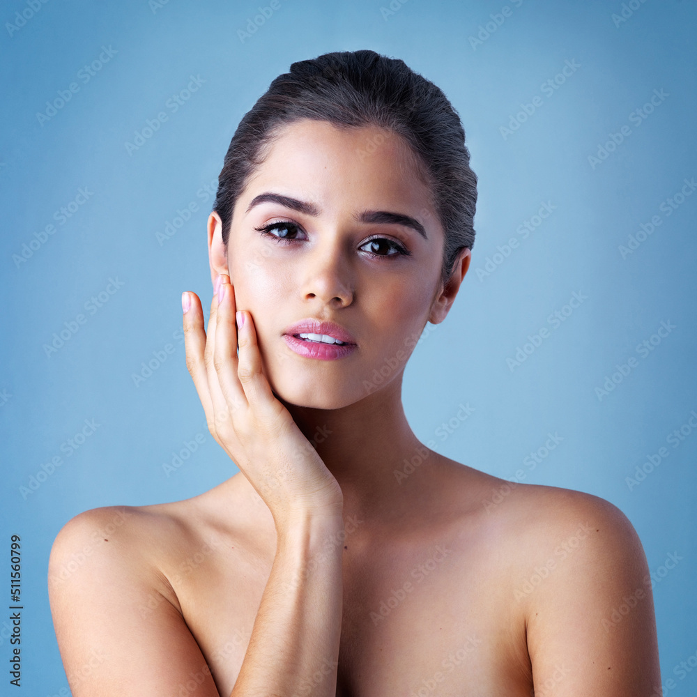 Behold A true beauty. Studio portrait of a beautiful young woman posing against a blue background.