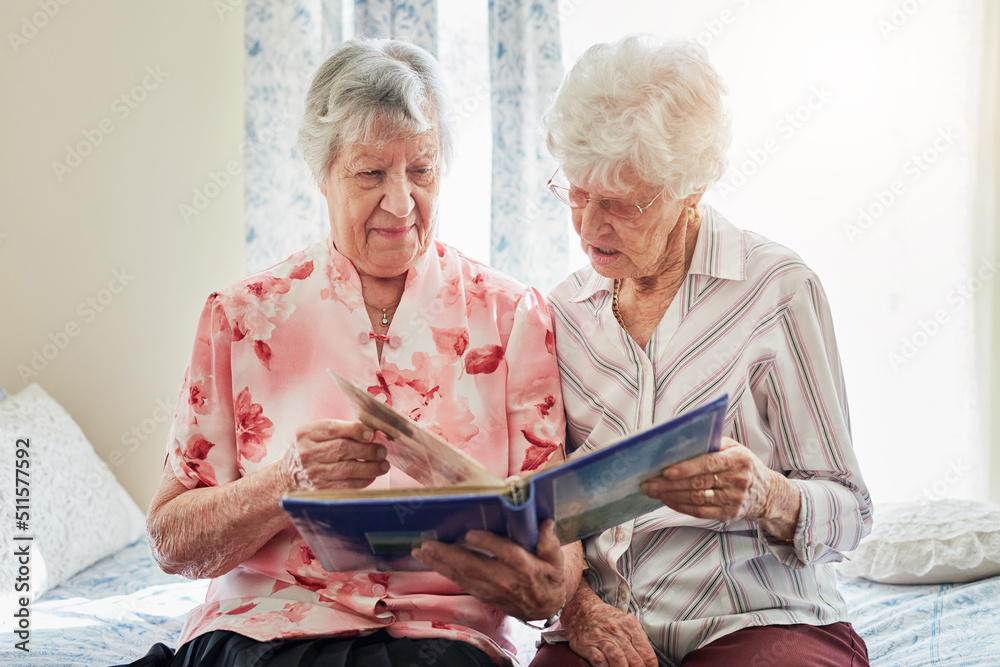 And this was me when I was younger. Shot of two elderly women looking through a photo album together