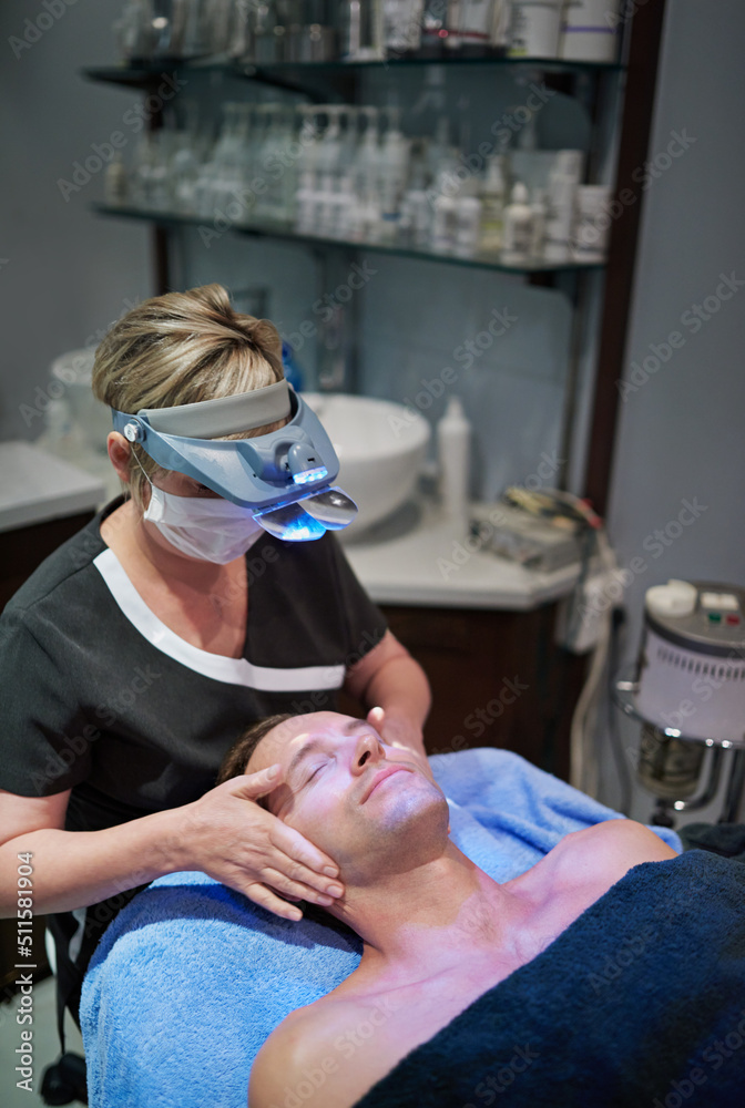 The health of his skin is in good hands. Shot of a man getting a facial treatment at a beauty clinic