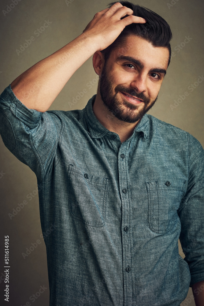 Theres always time for a fresh new cut. Studio shot of a handsome young man posing with his hand in 