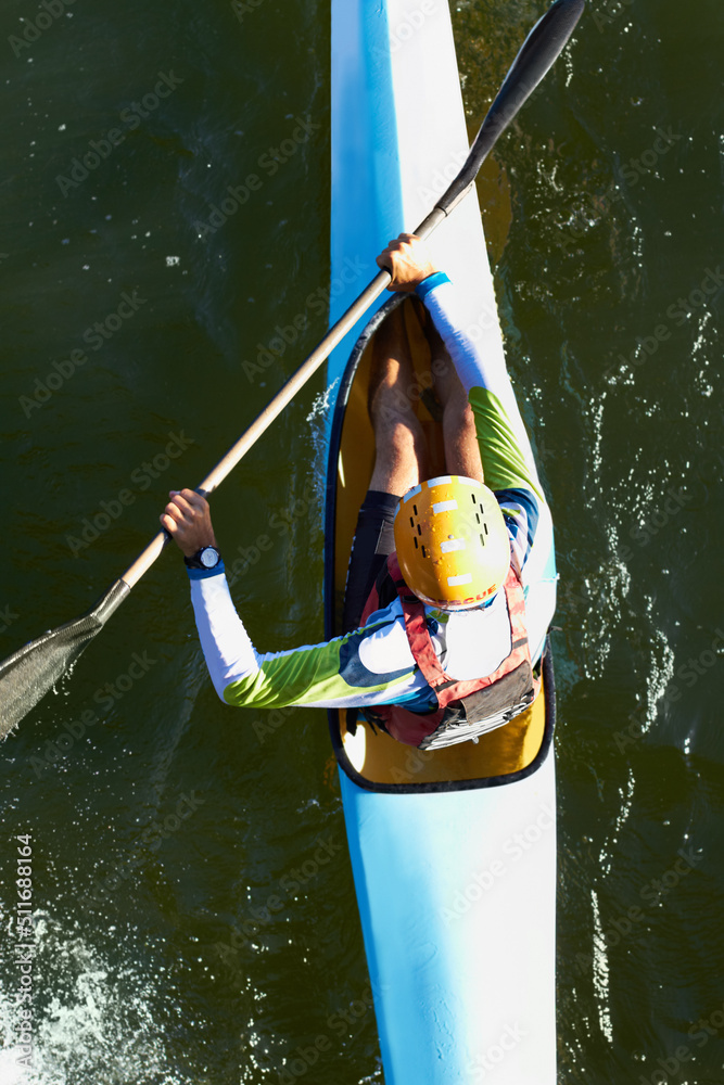 Just go with the flow.... A high angle shot of a man canoeing down a river.