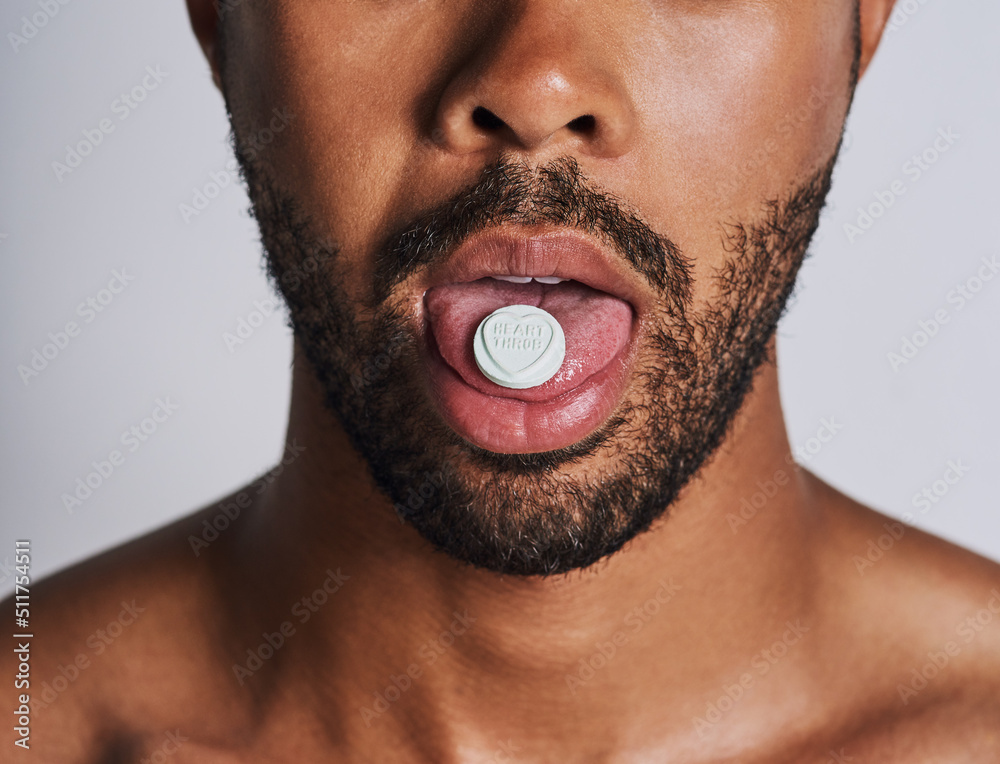 Living life on a high. Cropped shot of an an unrecognizable man taking medication against a grey bac