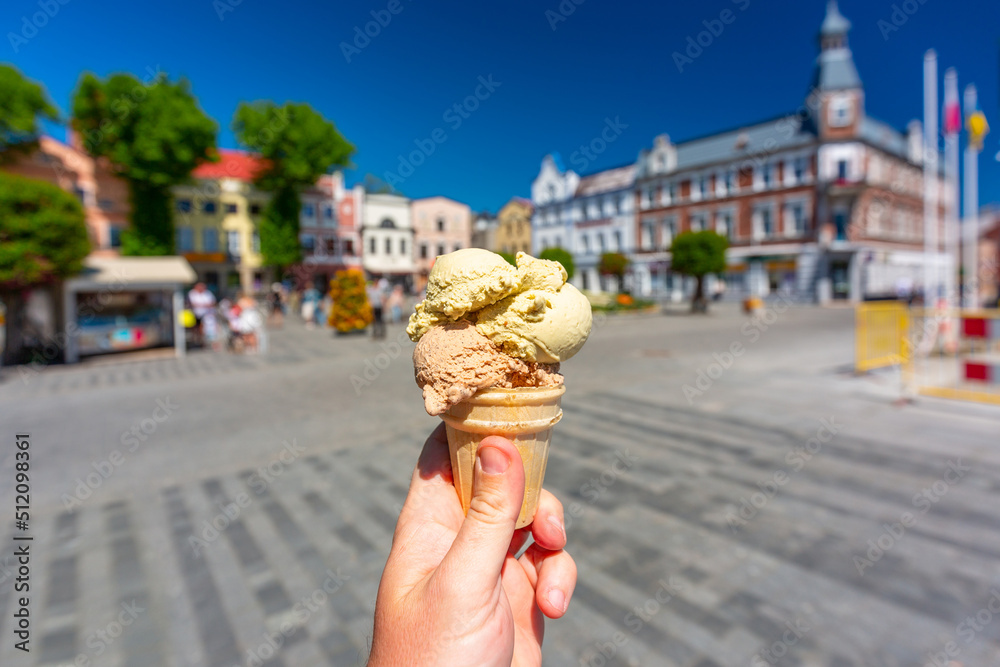 Pistachio and coffee ice cream in a cone on the market square in Puck. Poland