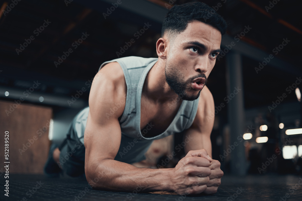 On the fast track to abs. Shot of a handsome young man doing a plank.