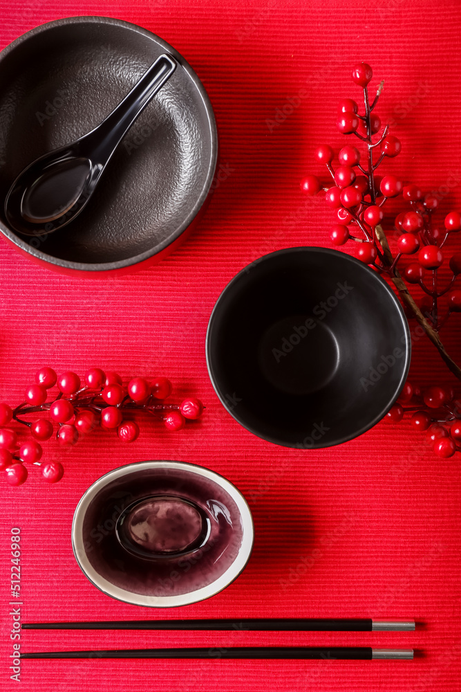 Chinese bowls with chopsticks and berries on table