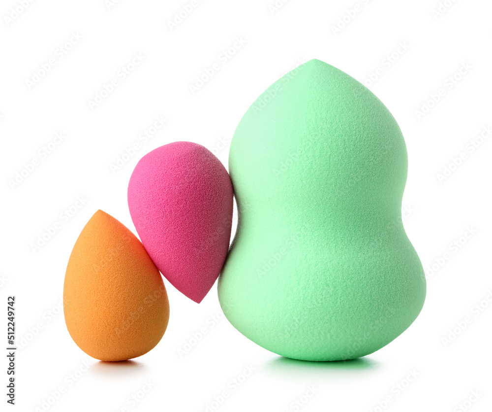 Different make up sponges on white background