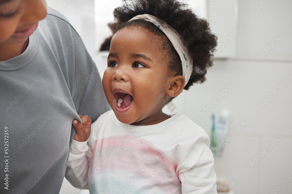 Look mom, its all clean. Shot of an adorable little girl opening her mouth to show her teeth to her 