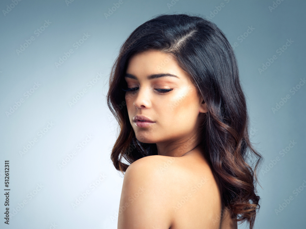 Perfect doesnt even begin to describe her beauty. Studio shot of a beautiful young woman posing agai