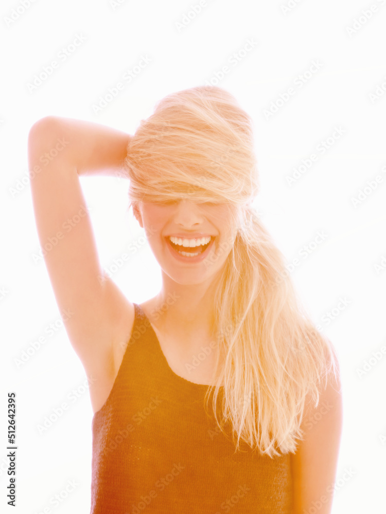 Ignorance is bliss. A young woman laughing with her hair covering her eyes.