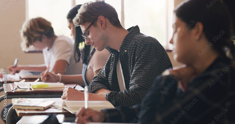 An A+ coming right up. Shot of teenagers writing an exam in a classroom.