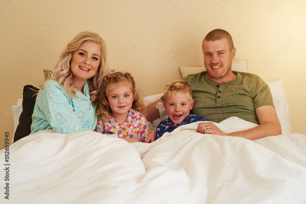 Family is not an important thing - its everything. Portrait of a happy family relaxing in bed togeth