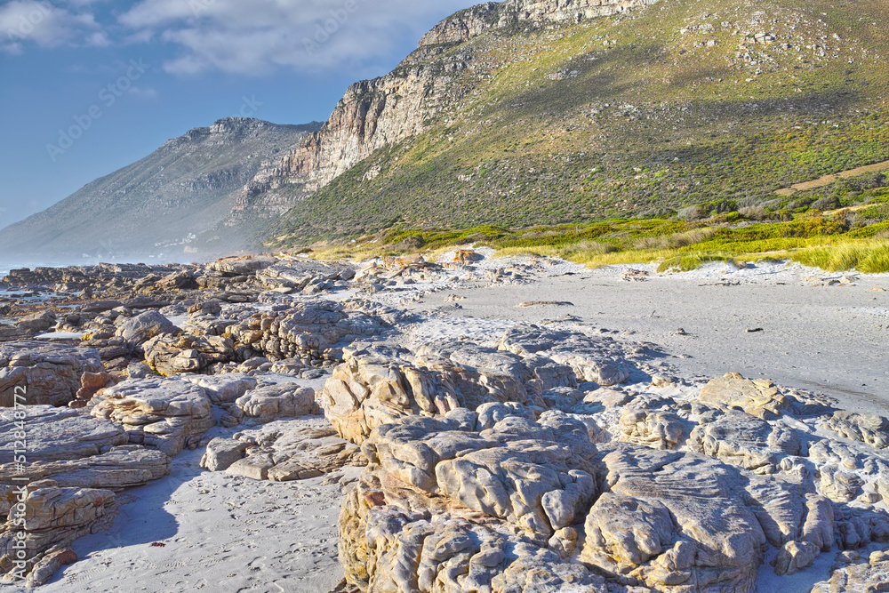 Landscape of rocks and mountains on a rocky beach in Cape Town, South Africa. An empty beach during 