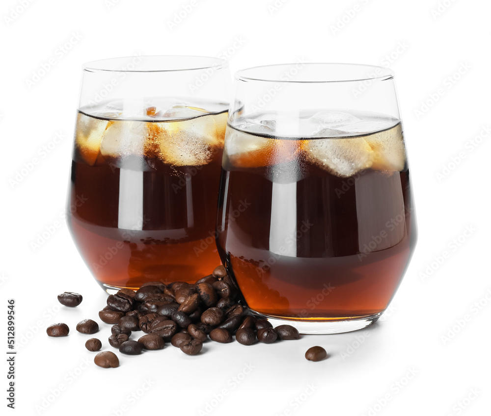 Glasses of cold brew and coffee beans on white background