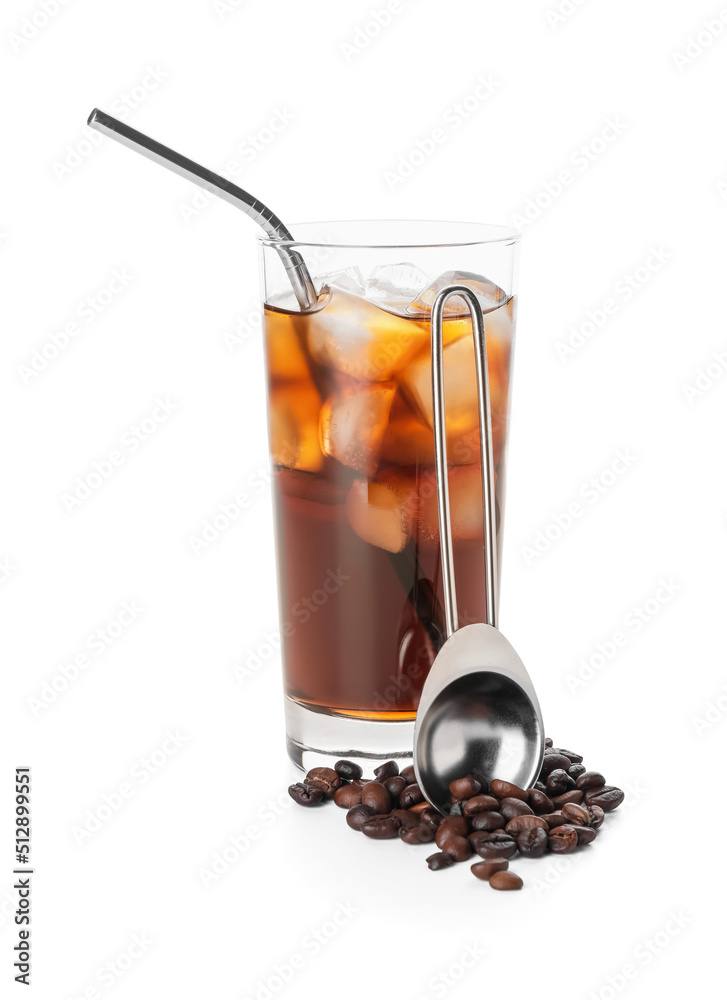 Glass of cold brew, coffee beans and spoon on white background