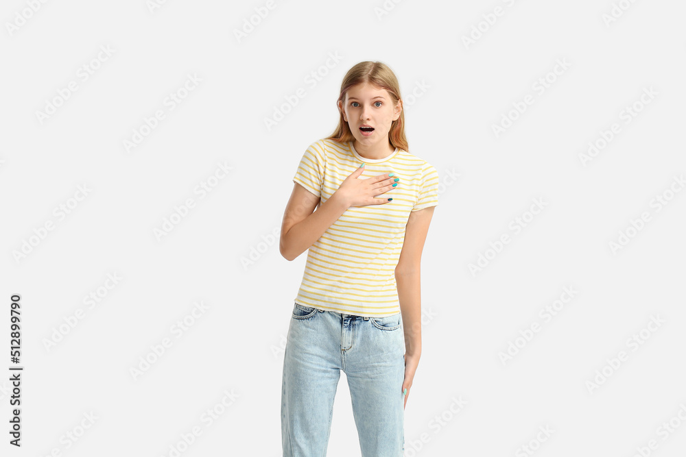 Shocked teenage girl in striped t-shirt on white background