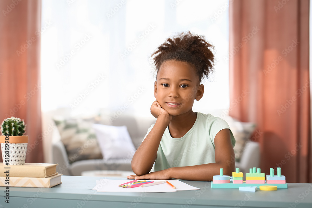 Little African-American girl sitting at home