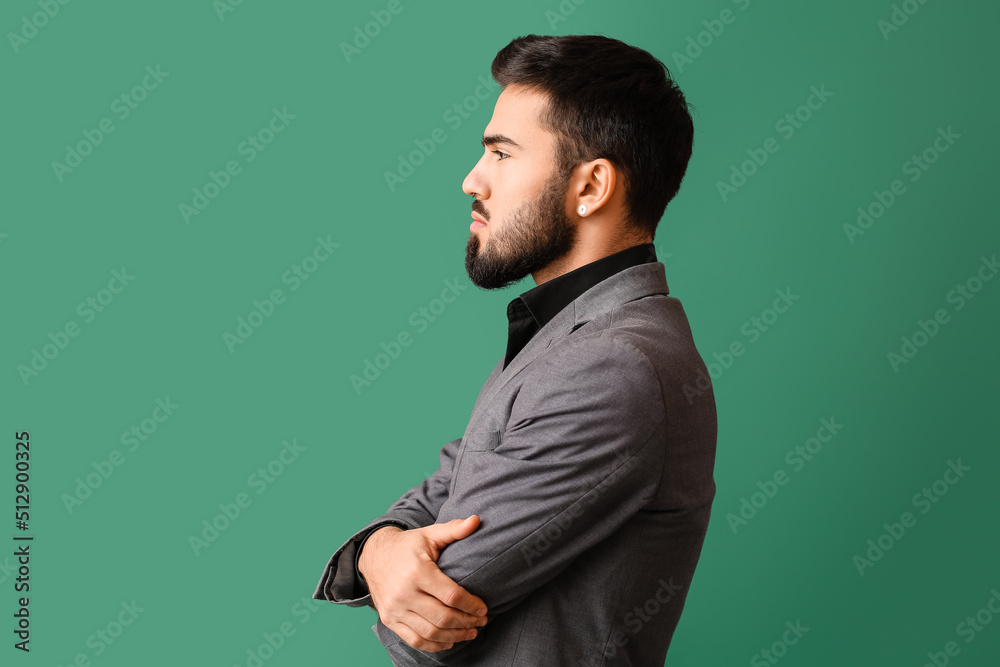 Profile of fashionable bearded man on green background