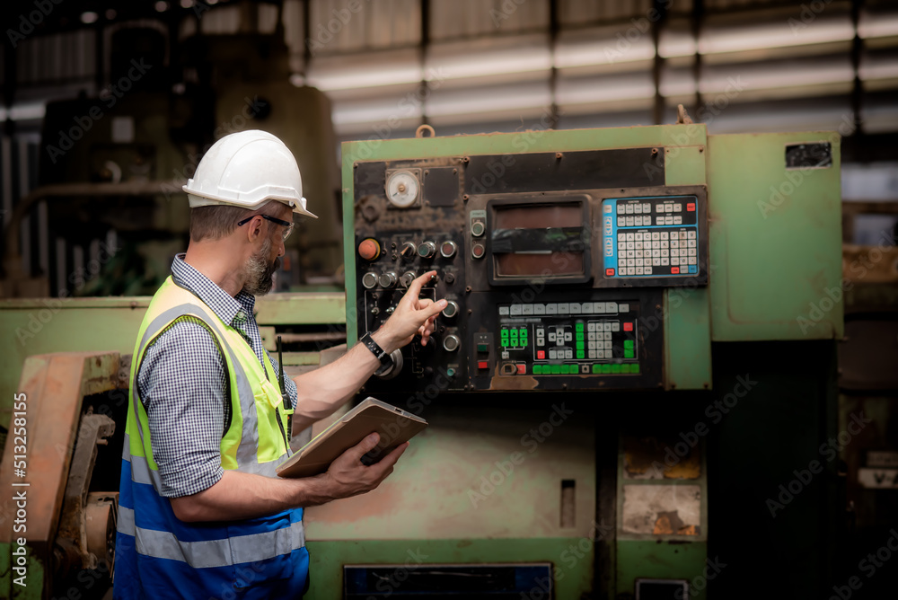 Caucasian male engineer or technician in safety uniform Working and checking machinery operation to 