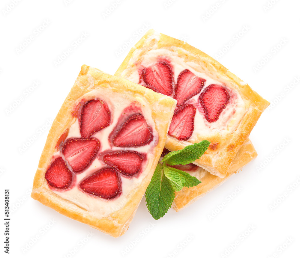 Strawberry puff pastries with mint leaves on white background