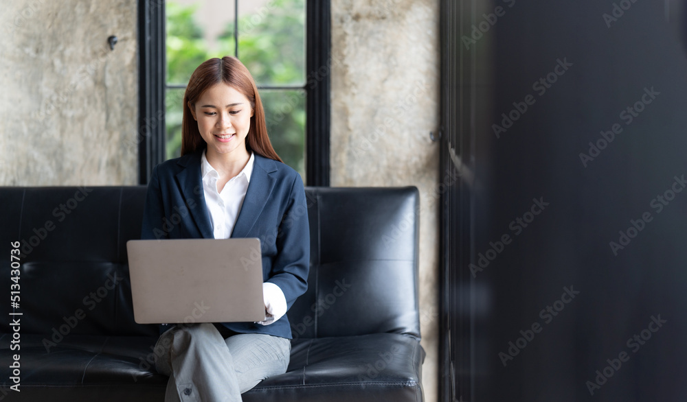 Asian woman typing email on laptop computer while sitting at home,Young Business Woman Working Creat