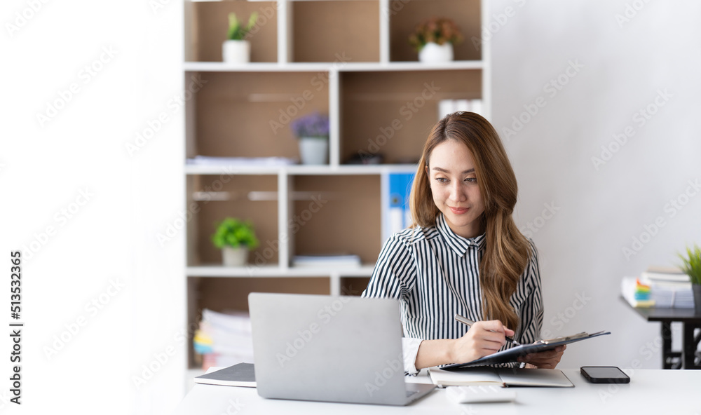 Portrait of businesswoman working with computer laptop on the table in modern meeting room.