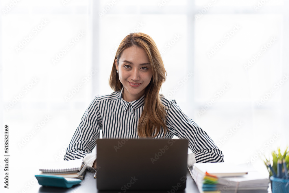 Portrait of businesswoman working with computer laptop on the table in modern meeting room.