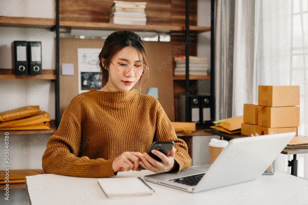 Asian woman SME working with a box at home the workplace.start-up small business owner, small busine