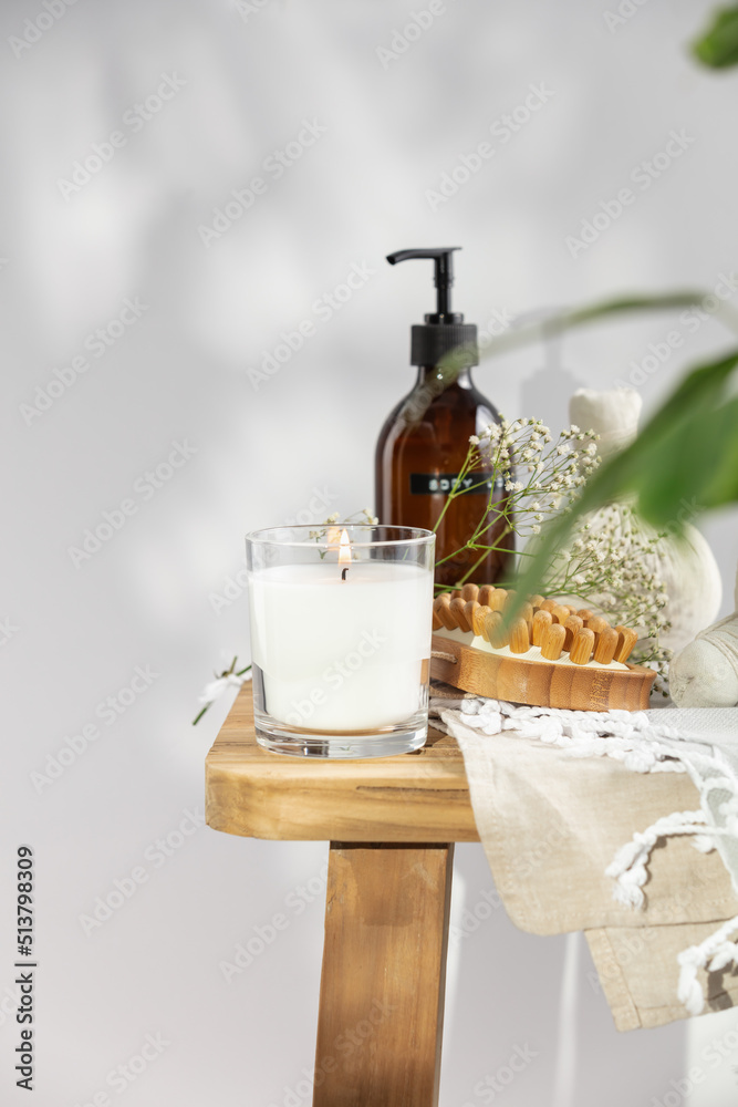 White scented candle, body lotion, anti-cellulite dry massage brush, herbal balls and delicate flowe