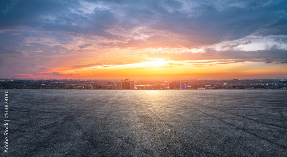 Empty asphalt road and modern city skyline with building scenery at sunset. high angle view.