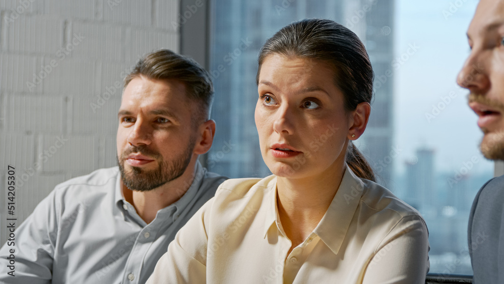 Portrait of a team of professionals communicating in a meeting while sitting at desk