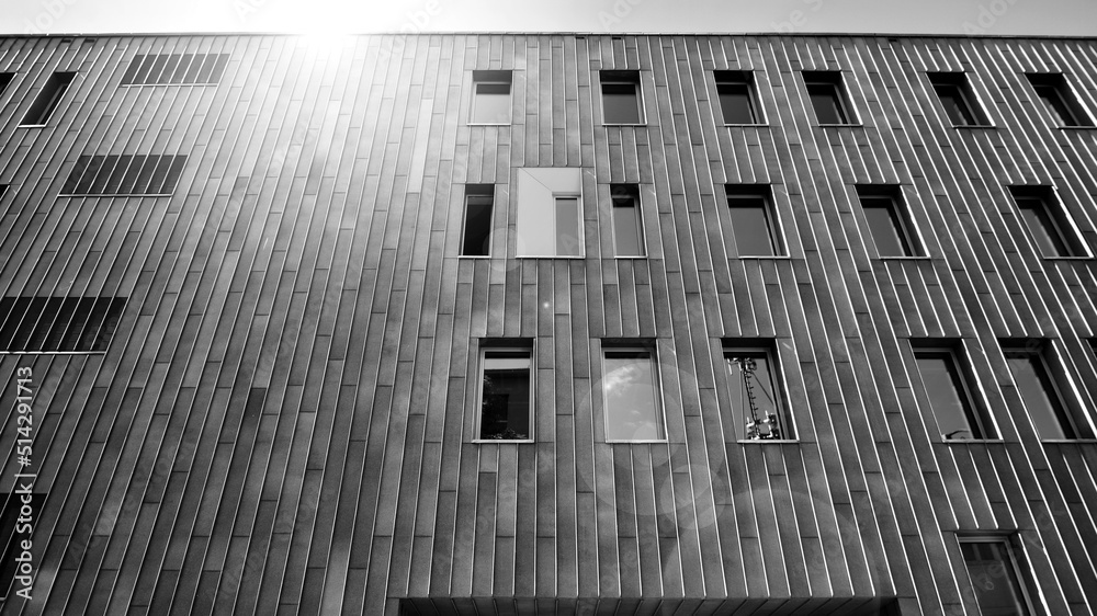 Fragment of modern urban geometry. Walls  office building made of steel and glass. Bright sunny day 