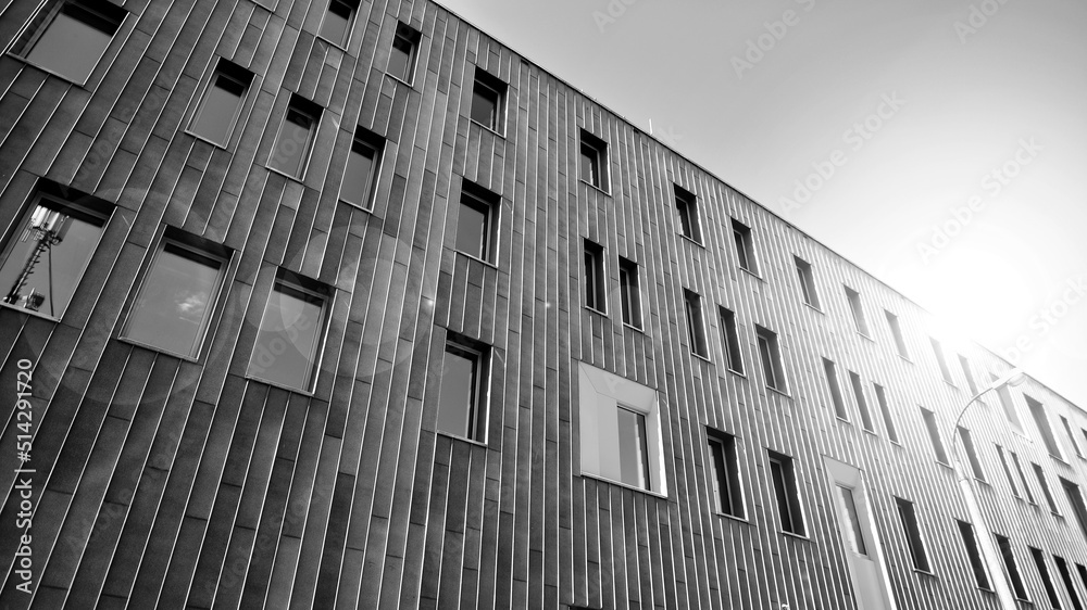 Fragment of modern urban geometry. Walls  office building made of steel and glass. Bright sunny day 