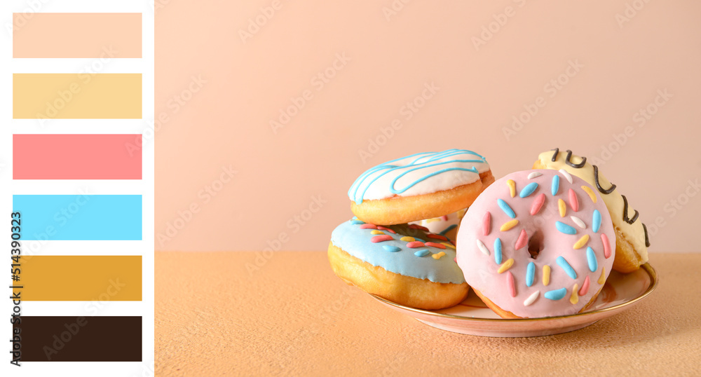 Plate with delicious donuts on table. Different color patterns