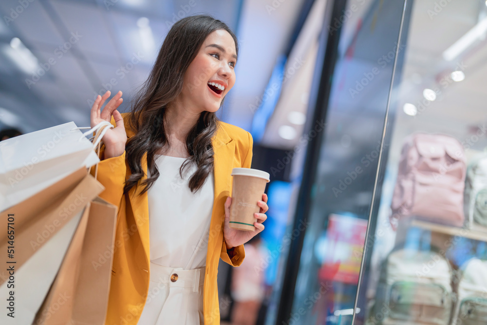 Beautiful asian female woman girl is holding shopping bags and coffee drink, walk and cheerful enjoy