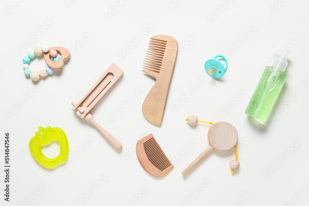 Wooden hair combs and different bath accessories for baby on white background