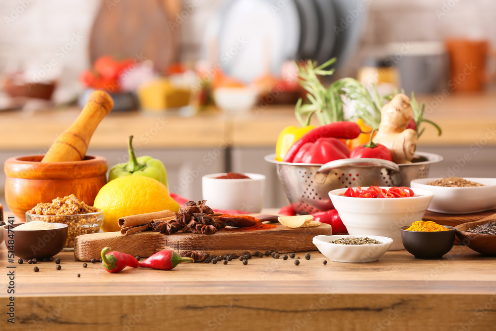 Different spices and products on table in kitchen