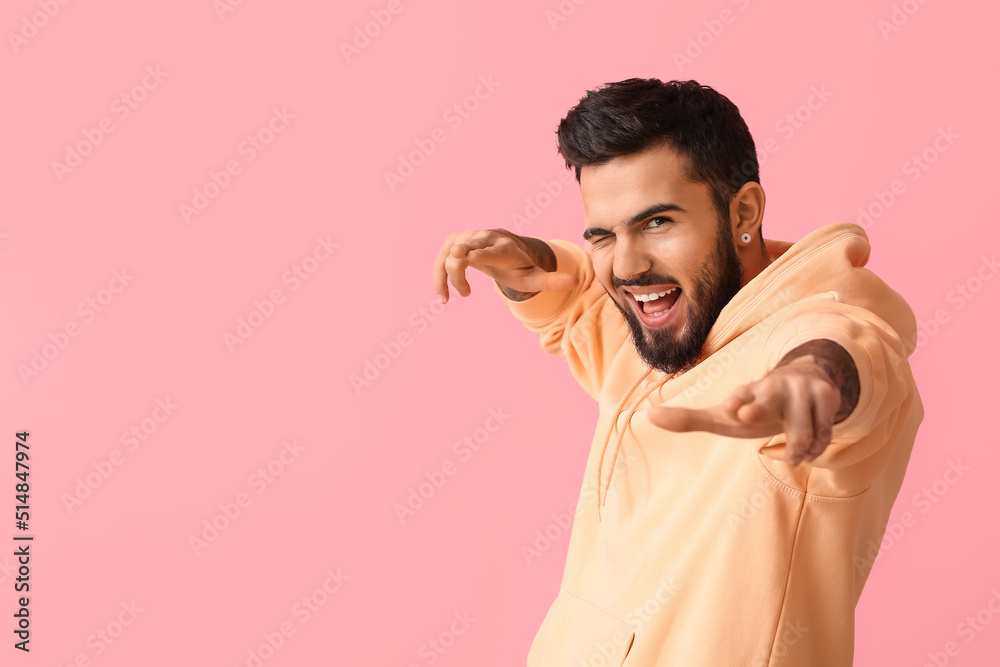 Emotional bearded man on pink background